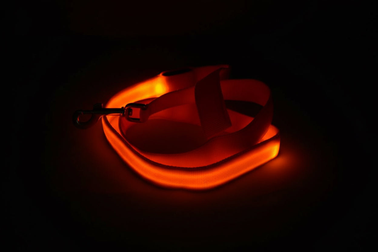 Neon orange glow stick with a black background
