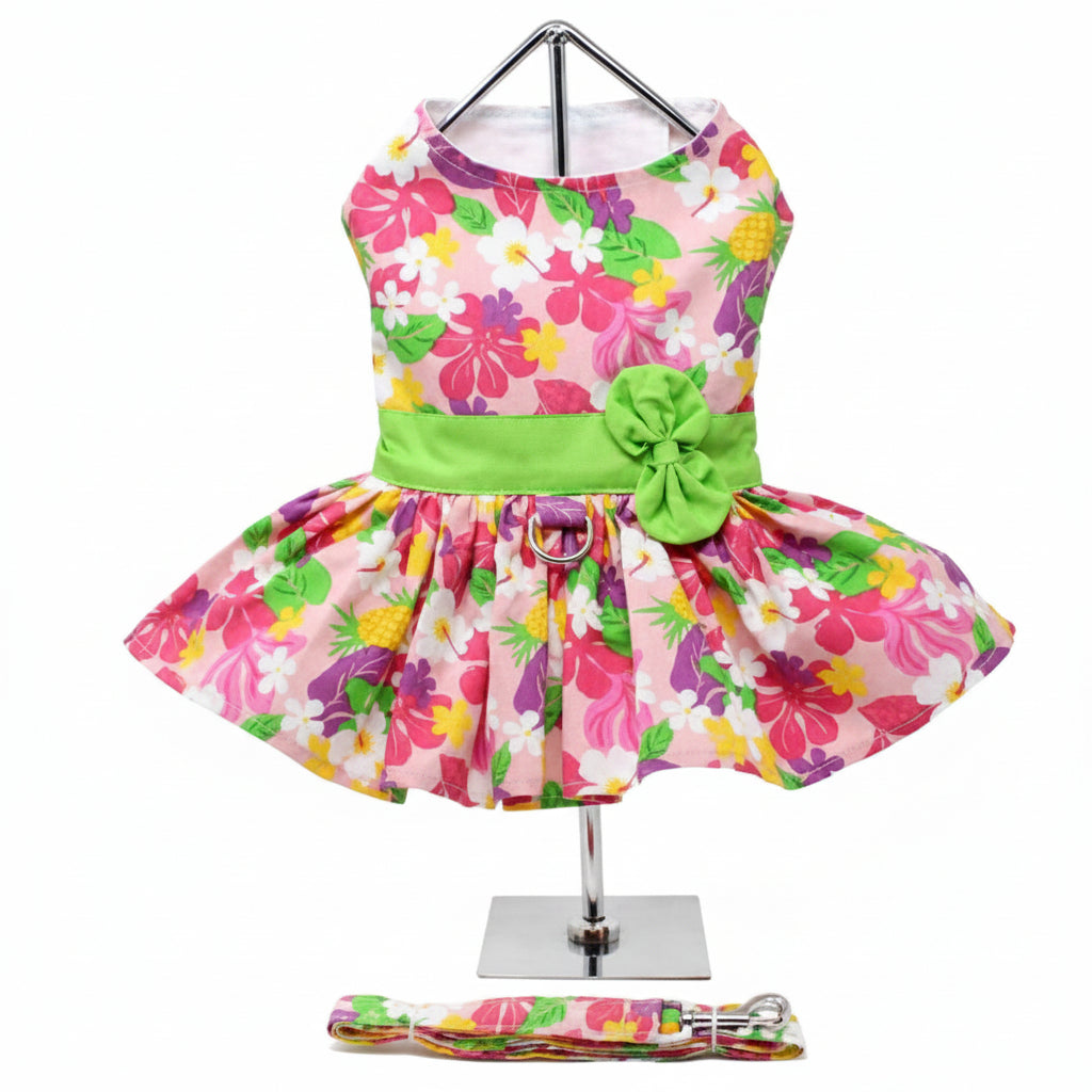Colorful floral dress with a green bow on a mannequin against a white background