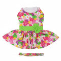 Colorful floral dress with a green bow and matching headband on a white background