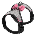 Dog harness with pink bow and rhinestone details on a white background