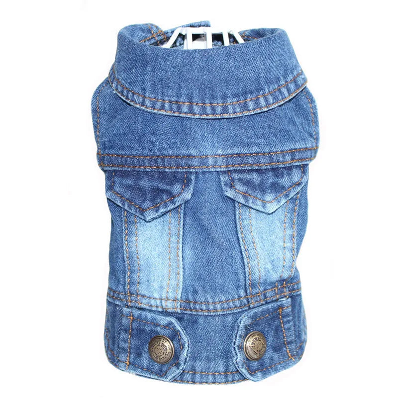 A blue denim pet jacket with a high collar, front flap pockets, and metal snap buttons, shown on a white background.