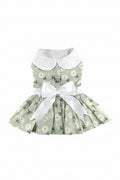 Green floral dress with white collar and bow on a white background