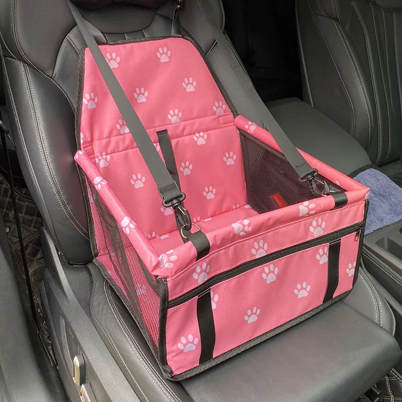 Pink pet seat cover with paw prints on a car seat