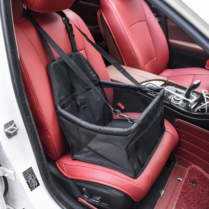 Black pet seat cover on a red car seat