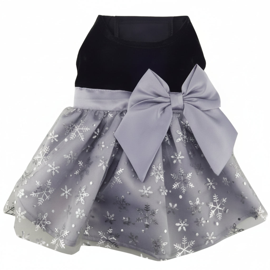 Children's dress with black top and gray skirt with snowflake pattern and large bow on a white background